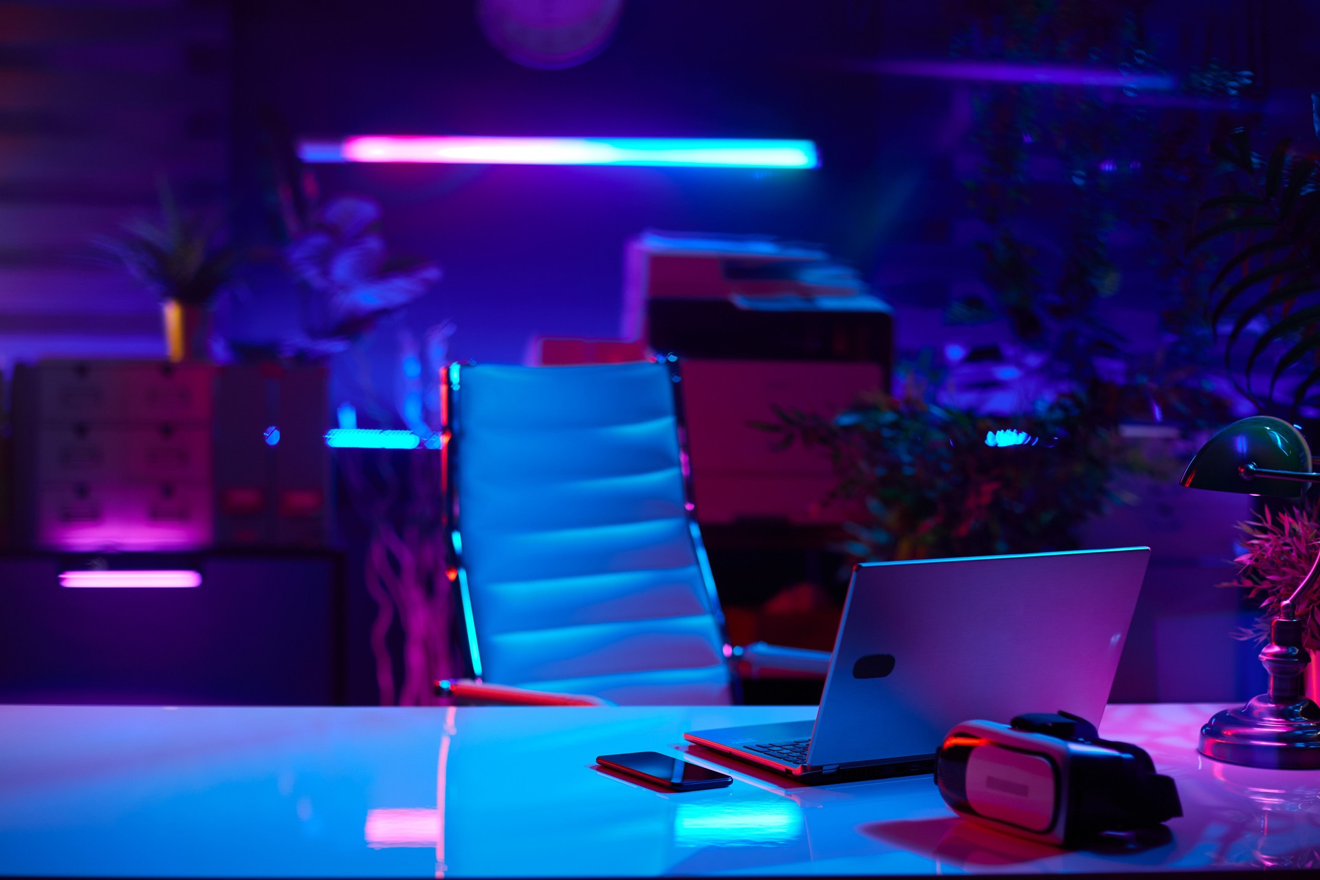 modern office with desk, laptop and virtual reality goggles
